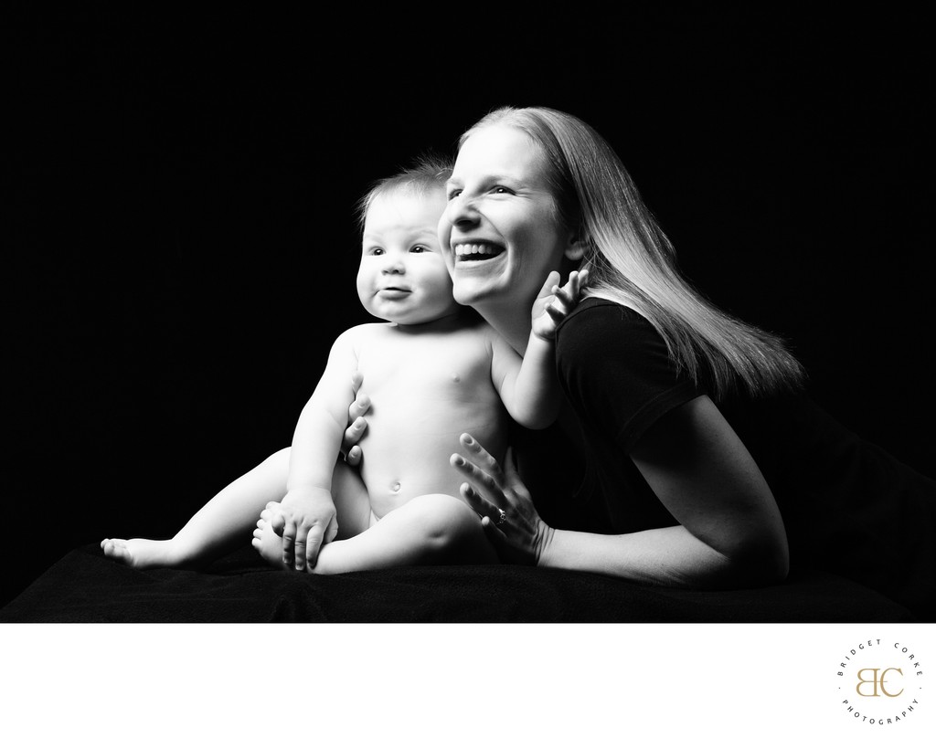 Joyful Mother and Baby Portrait in Black and White