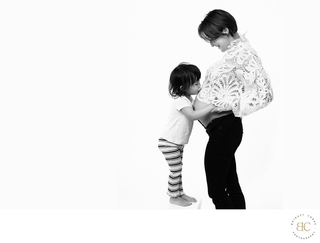 Joyful Maternity Portrait with Young Sibling