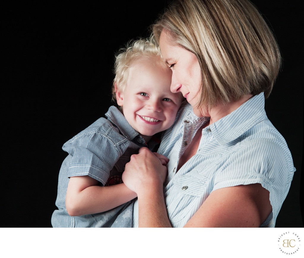 Blonde Son Wrapped in Mother’s Loving Arms