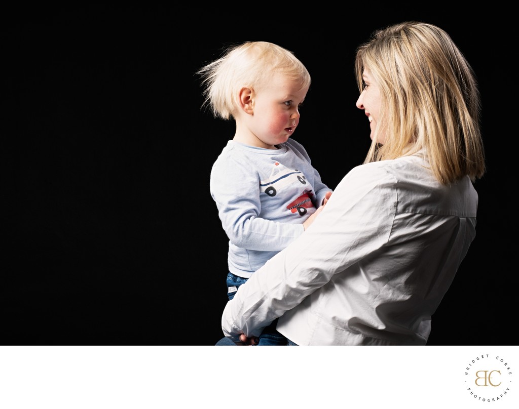 Mum Holding Toddler in Thoughtful Moment