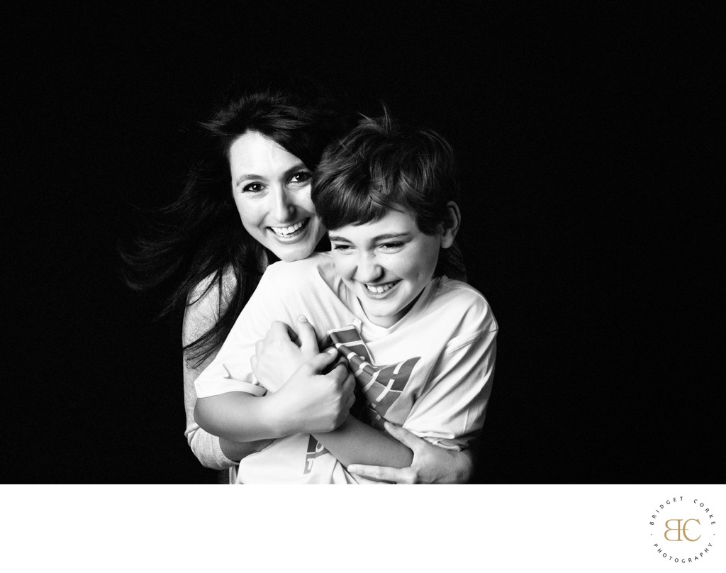 Laughing Mother Hugging Her Pre-Teen Son