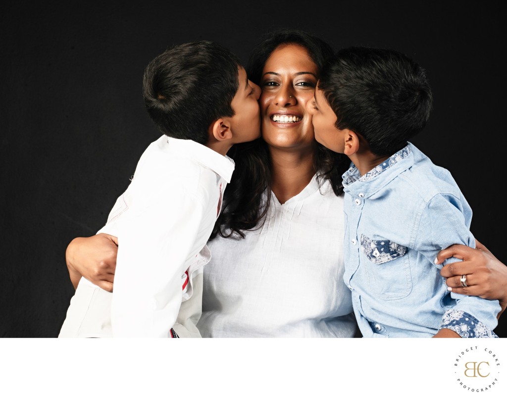 Mum Being Kissed by Her Two Sons