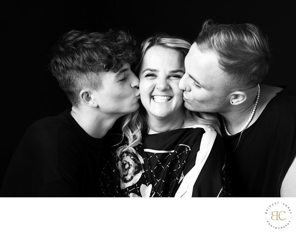 Mum Beaming Between Kisses