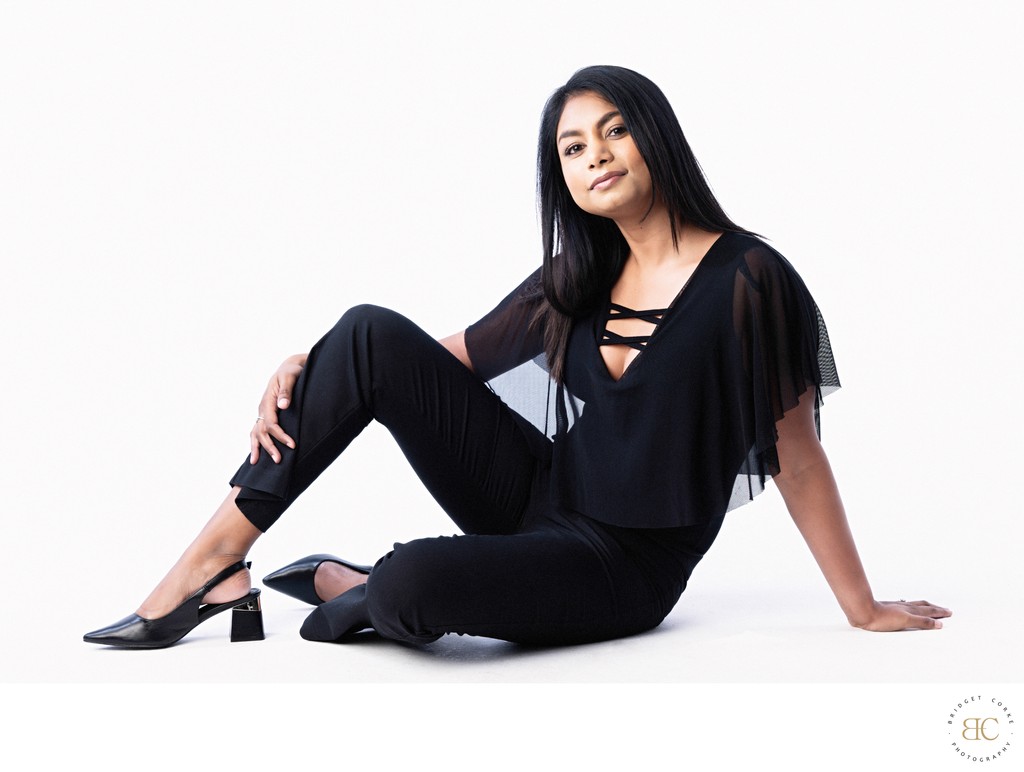 Confident Seated Portrait in Elegant Black Outfit