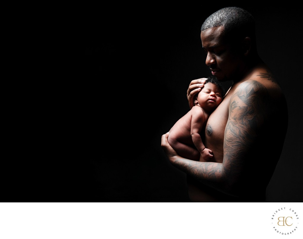 Father’s Strength: Cradling Newborn in Love