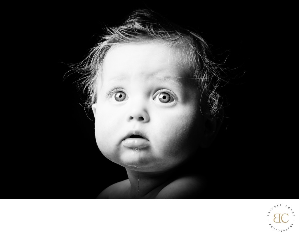 Wide-eyed black-and-white baby portrait in Johannesburg