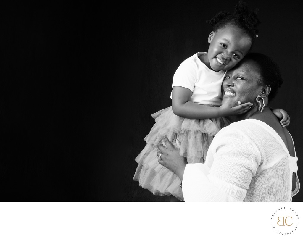 Mother and daughter with child on shoulders