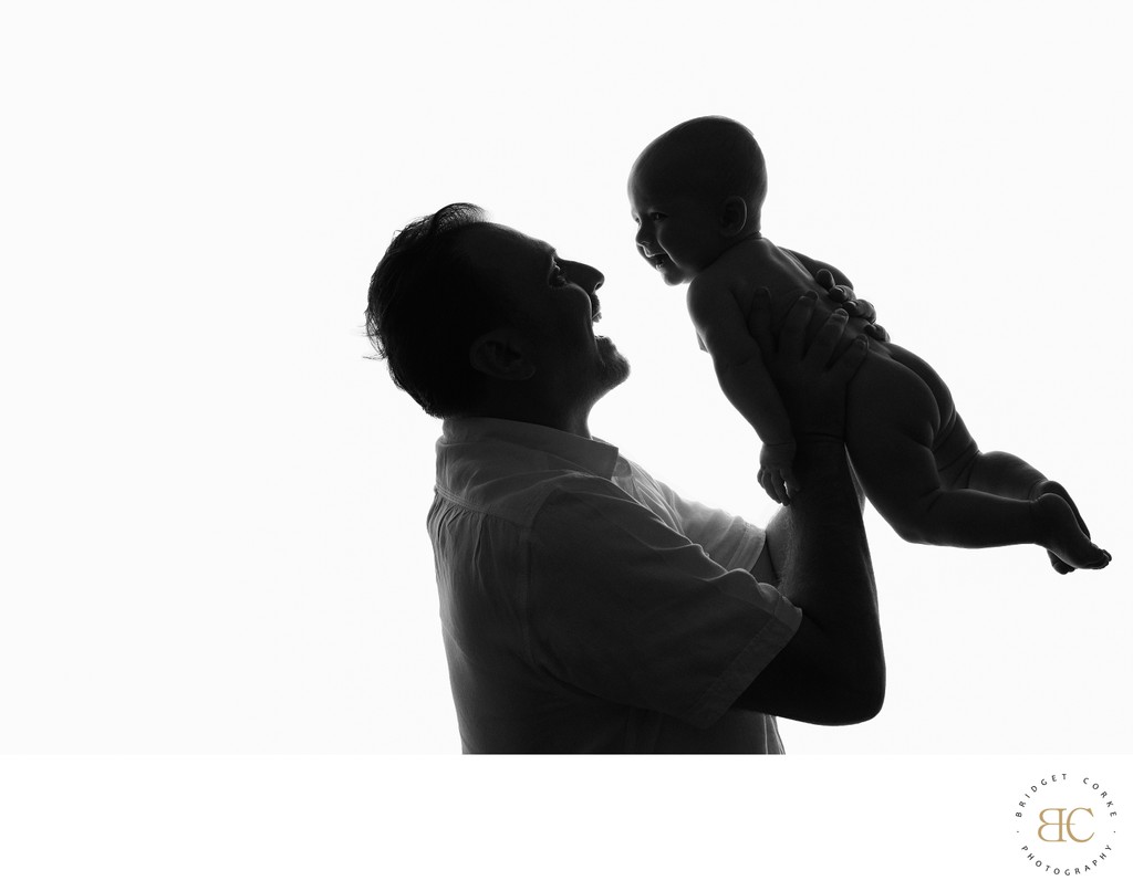 Father Lifting Baby Portrait