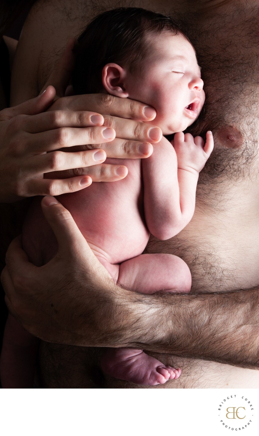 Newborn Sleeping Against Dad's Chest