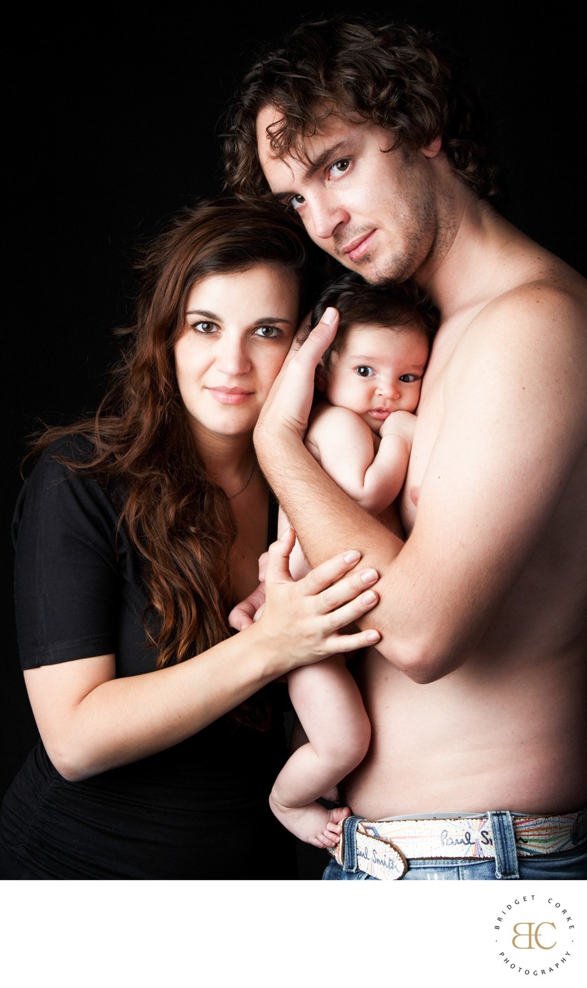 Dad Holding Newborn To His Chest