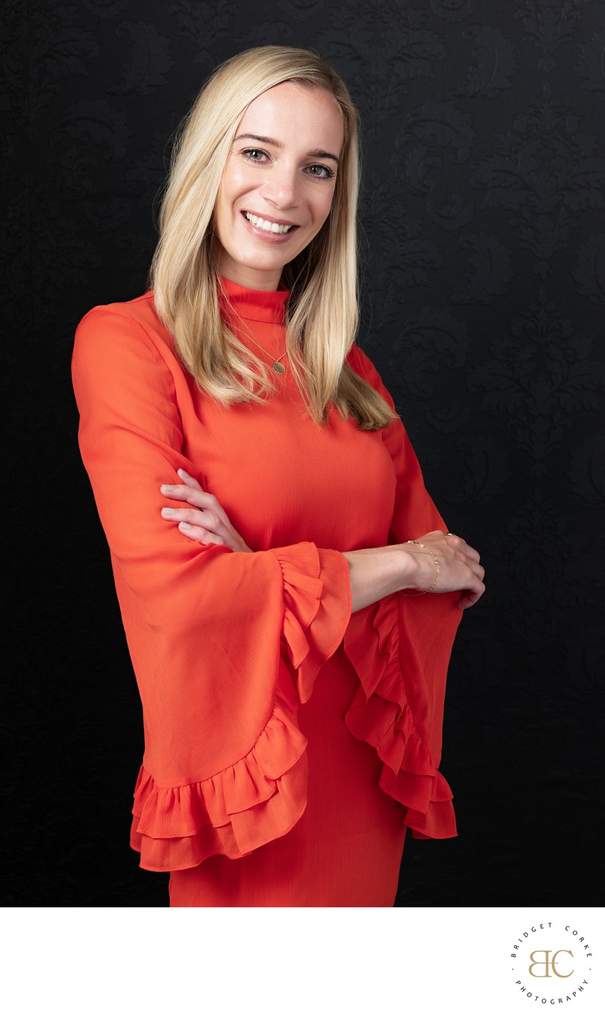 Vibrant Professional Headshot in Orange Dress