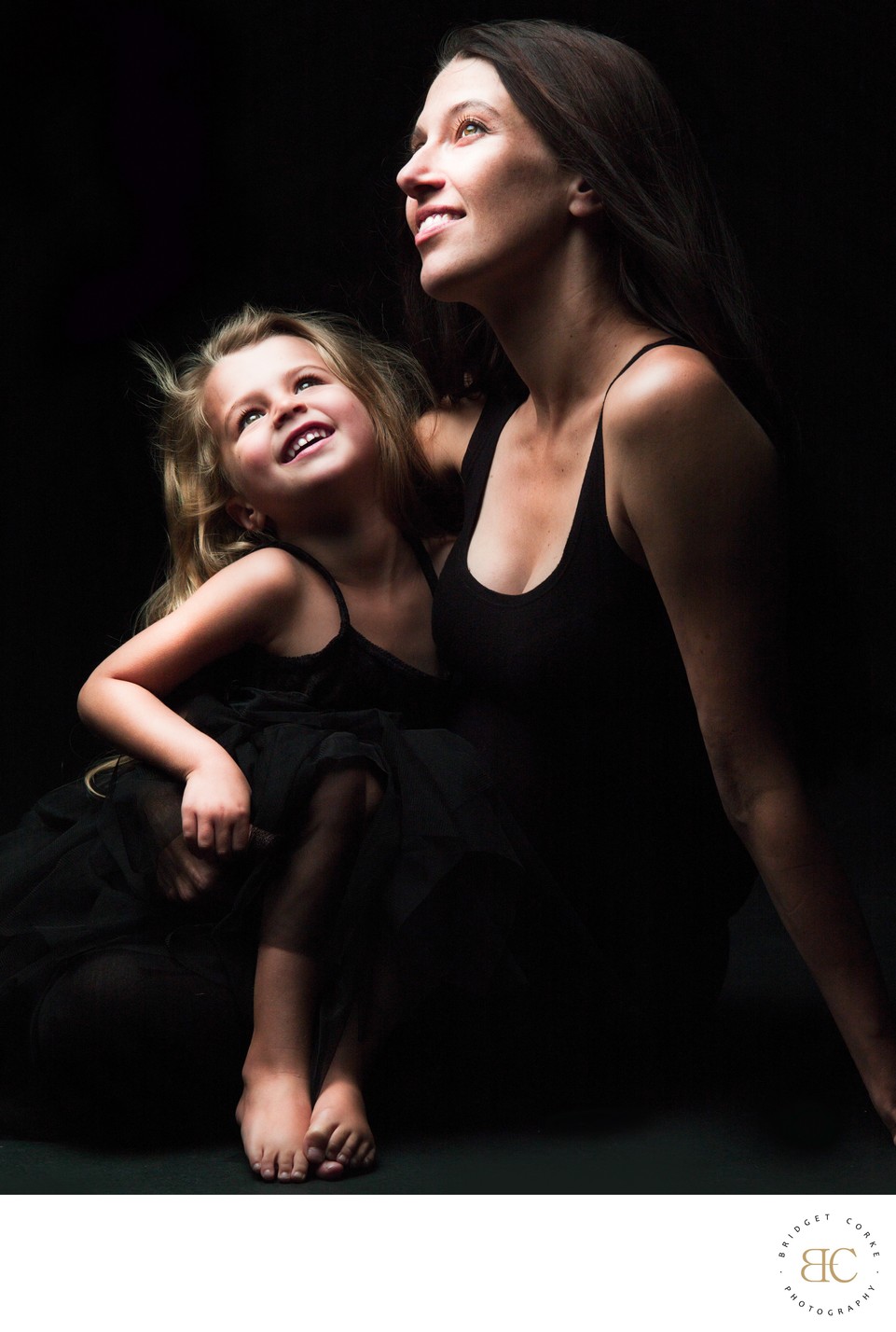 Elegant Mother and Young Daughter in Black Dresses