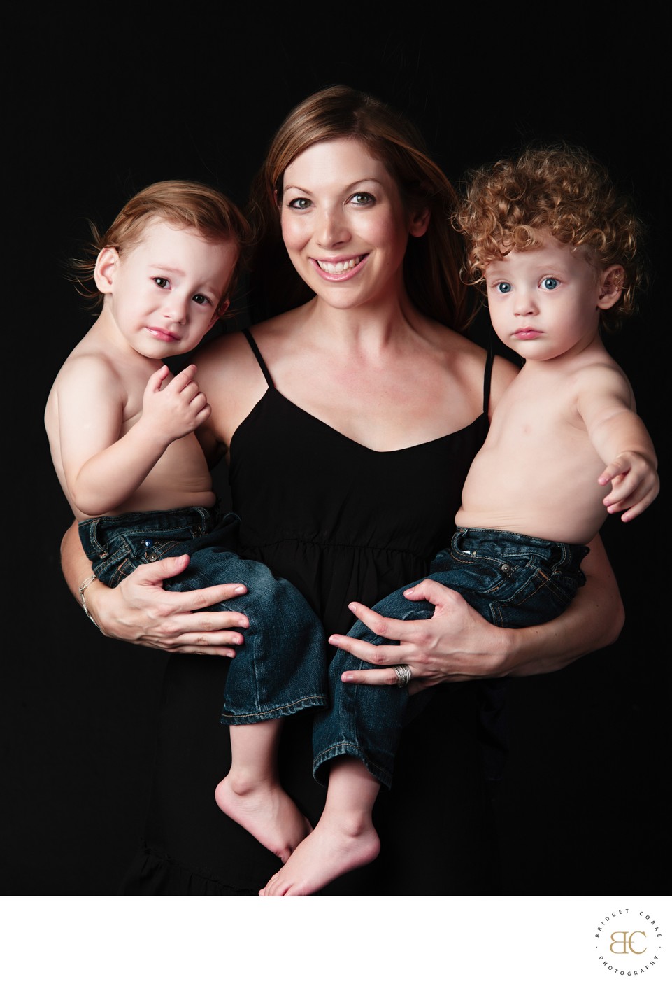 Mum Holding Her Twin Sons in Studio Portrait