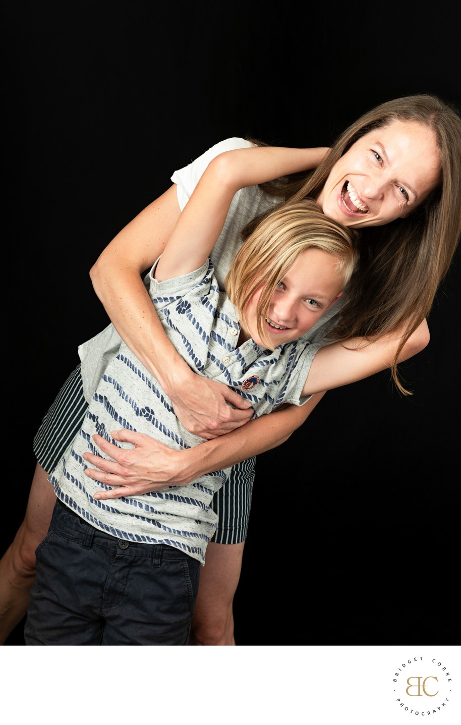 Playful Hug Between Mum and Her Laughing Son