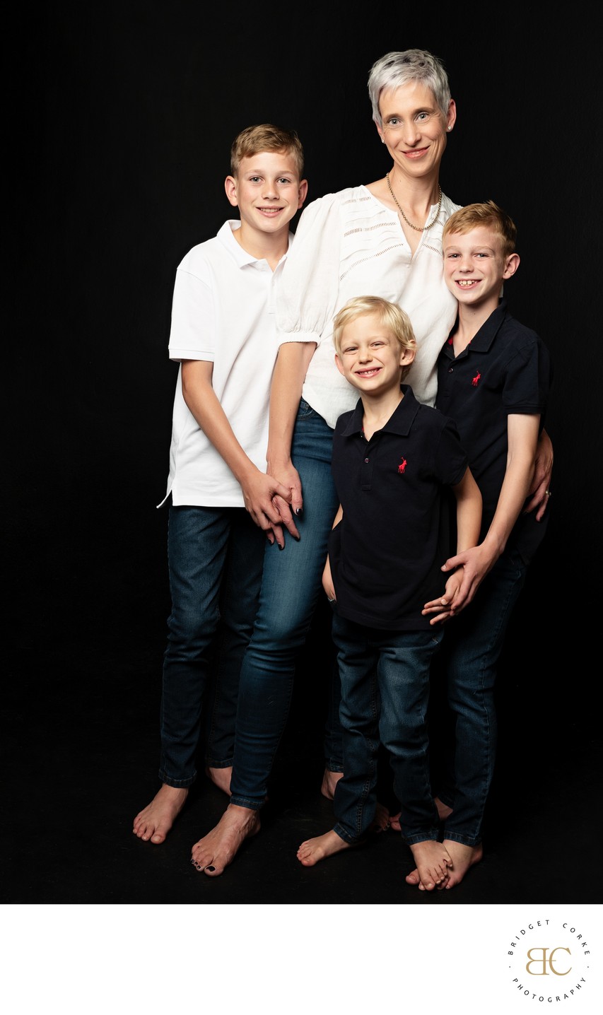 Mum with Her Three Barefoot Sons in Studio Light