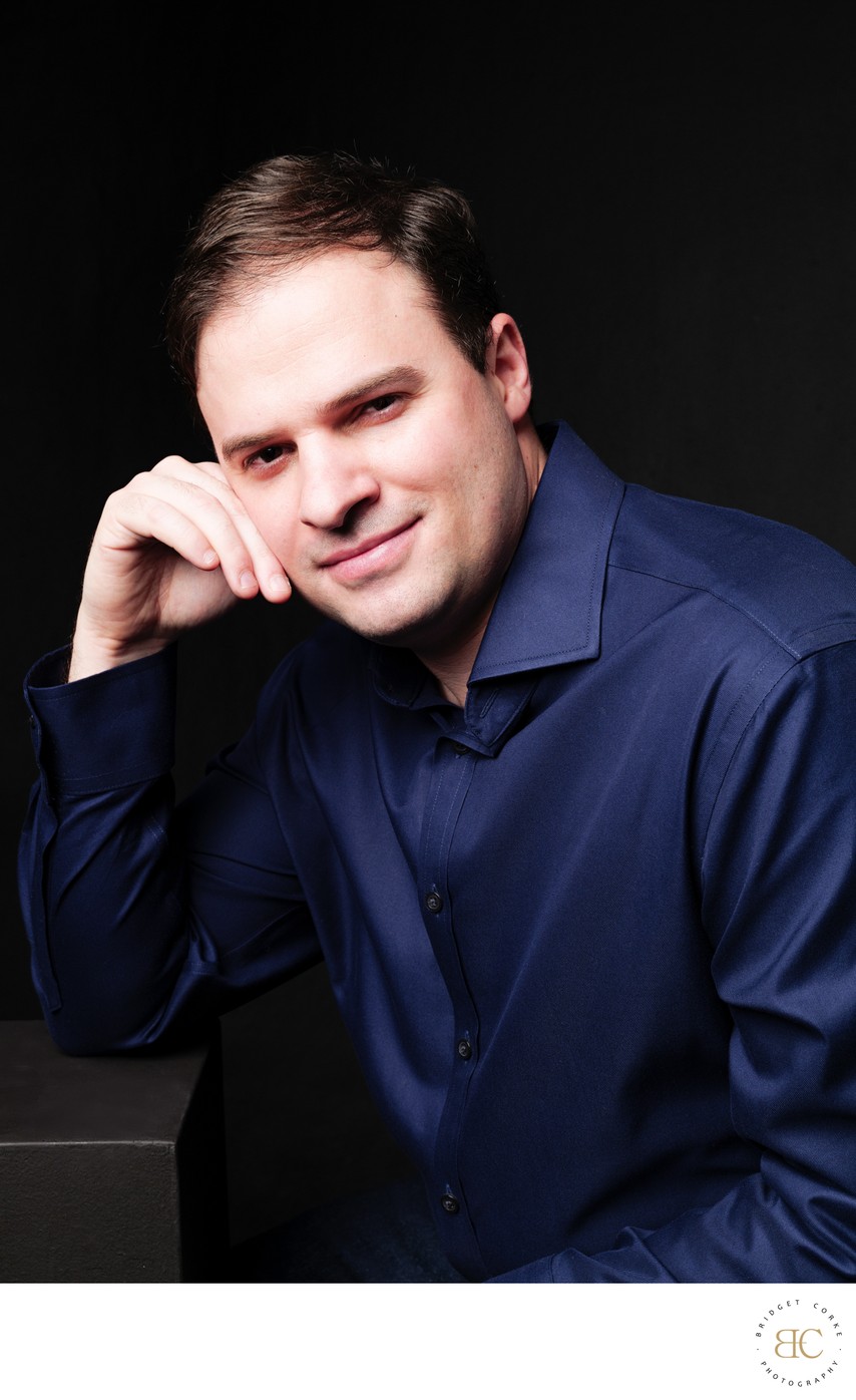 Confident Man in Navy Shirt Studio Portrait