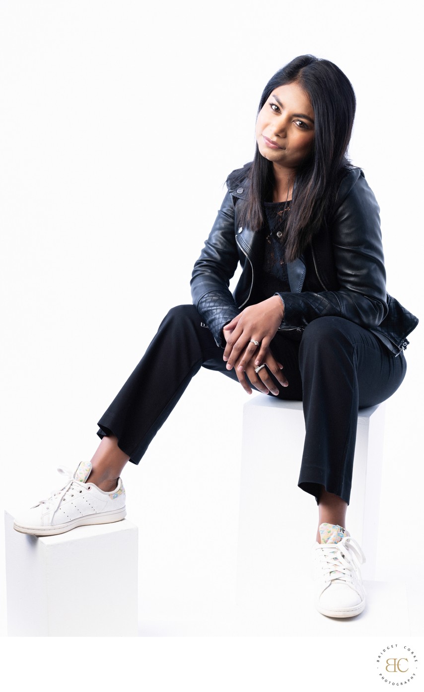 Modern Portrait of Woman in Leather Jacket and Sneakers
