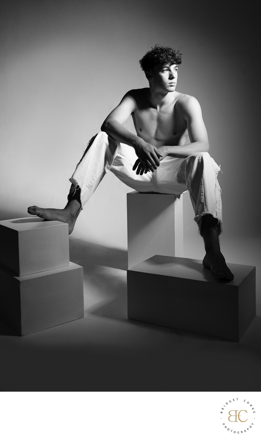 Model in White Jeans Seated on Blocks