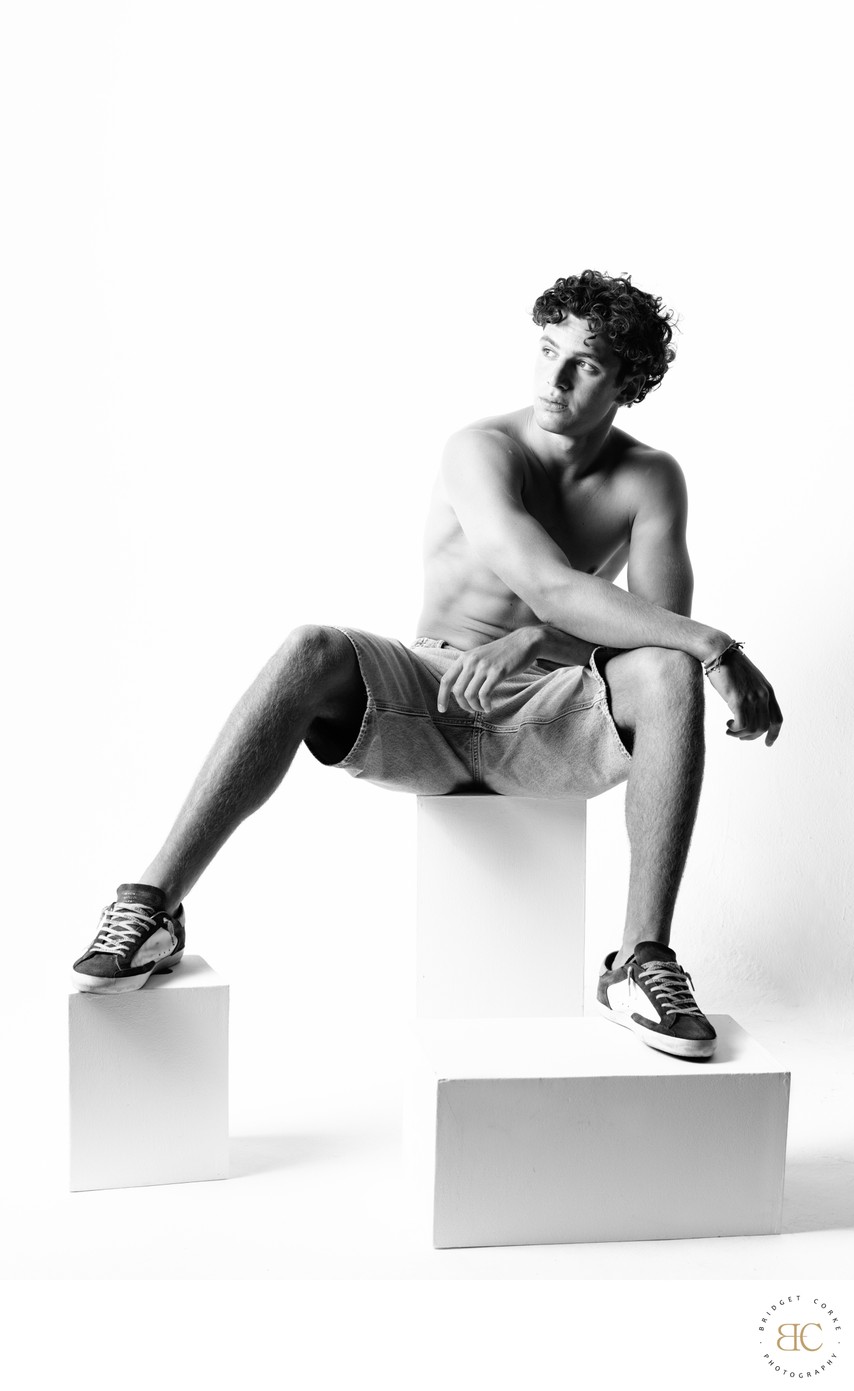 Seated Male Model in Monochrome Studio