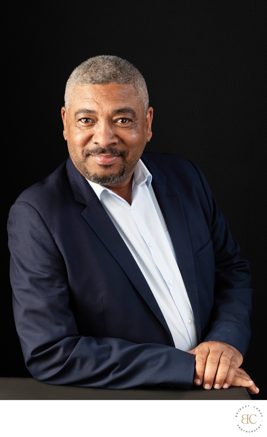 Seated professional headshot of a man