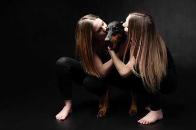 Doberman Dog Being Kissed