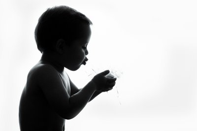 Boy Blowing Dandelion Silhouette