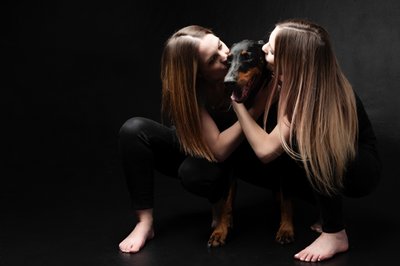 Doberman Dog Being Kissed