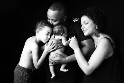 Family Embracing Newborn