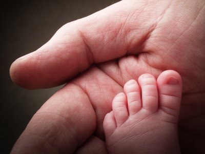 Newborn Foot In Dad's Hand