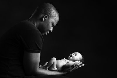 Newborn Yawning In Dad's Arms