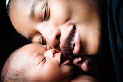 Newborn and Mom Smiling Cheek To Cheek