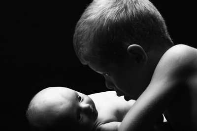 Boy Staring Newborn Brother