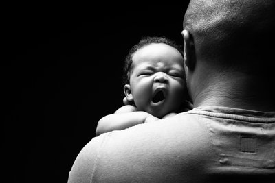 Newborn Yawning Over Dad Shoulder