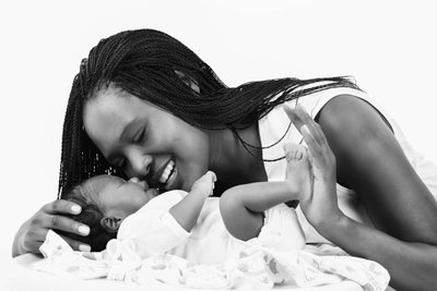 Newborn And Mom Wearing All White Wardrobe