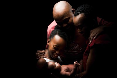 Newborn Surrounded By Family