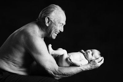 Grandpa Holding Newborn Granddaughter