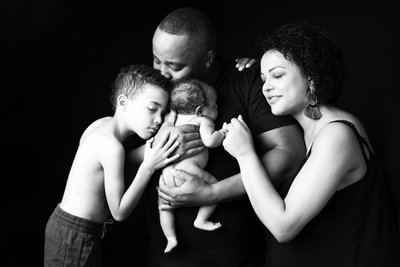 Family Embracing Newborn