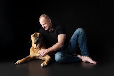 Bullmastiff and Man Seated