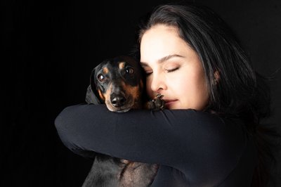 Black Dachshund Being Hugged By Lady