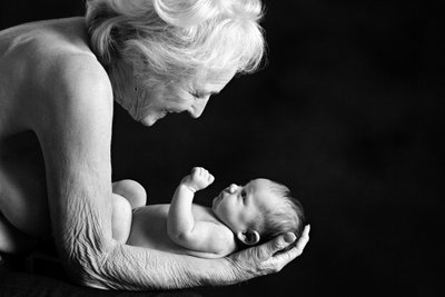 Timeless Touch: Grandmother Holding Newborn Baby