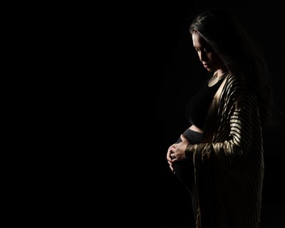 Elegant Gold-Trimmed Robe Maternity Portrait in Studio