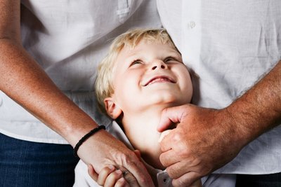 Parents Loving Embrace with Child Looking Up