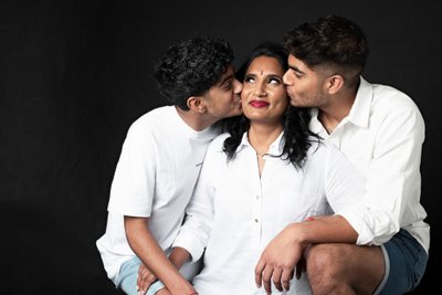 Mother with Sons Sharing Tender Moments in White