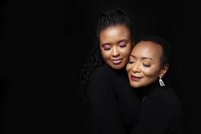 Elegant Mother and Daughter Embrace Portrait