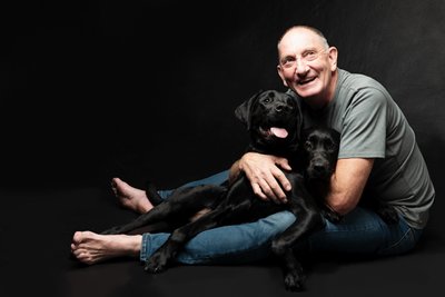 Heartwarming Portrait of Man with Black Labradors