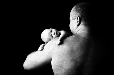 Tender Moment: Newborn Resting on Father's Shoulder