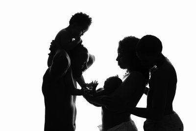 Family Silhouette: Embracing the Newborn