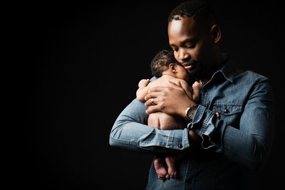 Father's Loving Embrace: Newborn Comfort