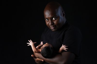 Proud Father: Holding Newborn with Care