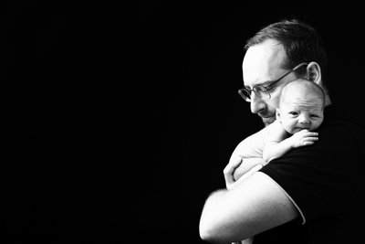 Father and Newborn Embrace Portrait